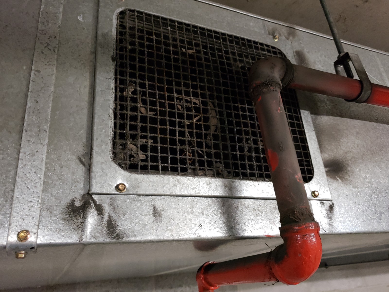 leaves and debris blocking extract grilles in carpark ventilation system